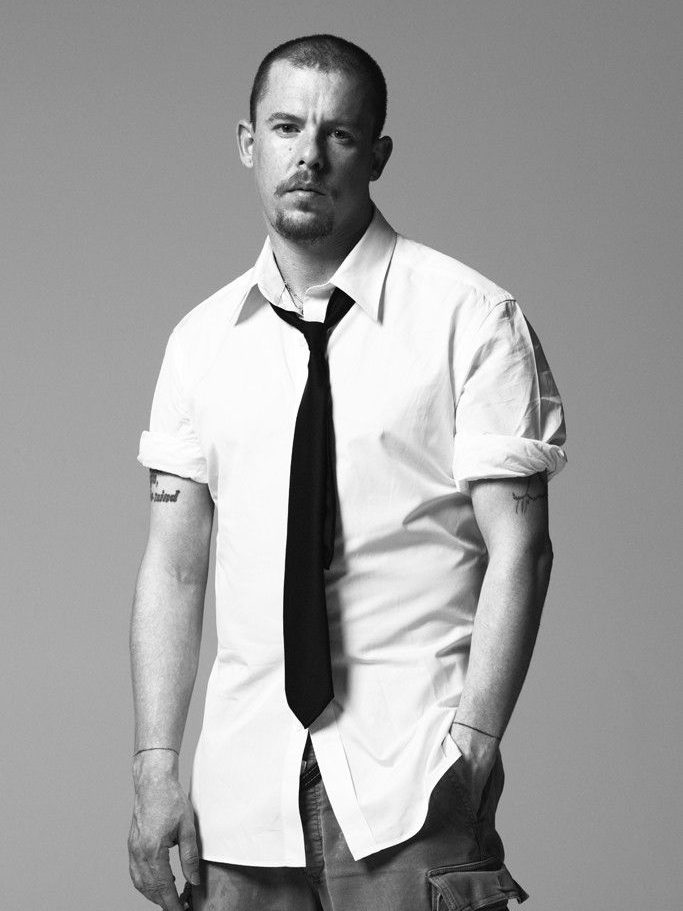 Man standing with one hand in pocket waring a short-sleeve button-up shirt and a loose necktie