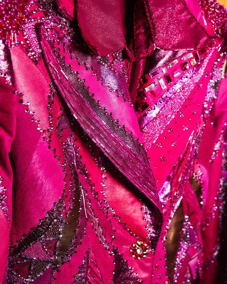 Close-up of a pink garment with intricate beadwork and sequin embellishments